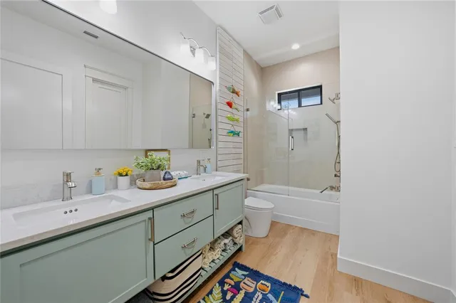 a spacious bathroom with a sink mirror vanity and toilet