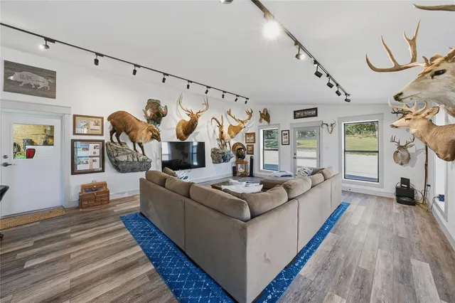 a large kitchen with stainless steel appliances a stove a sink dishwasher and cabinets with wooden floor