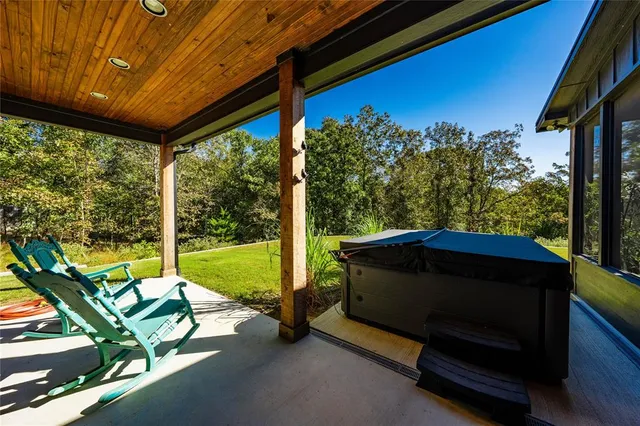 an aerial view of a house with yard swimming pool and outdoor seating