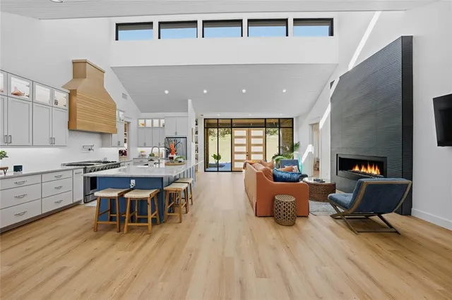 a living room with furniture a fireplace and wooden floor