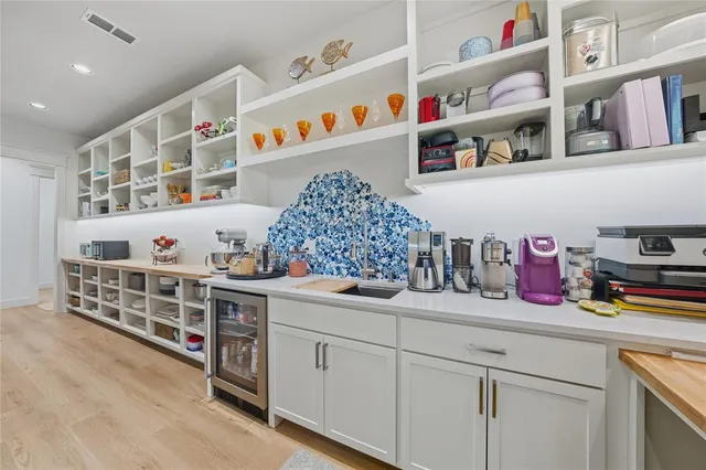 a kitchen with stainless steel appliances cabinets and window