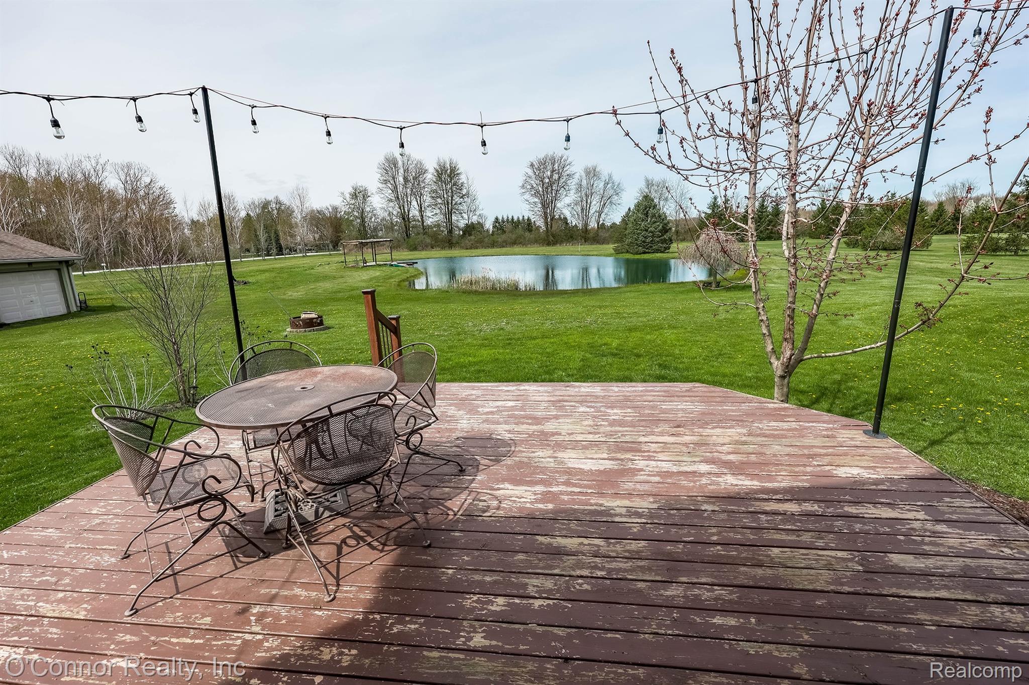 7978 Frith Road Columbus, MI 48063 - Photo 34 of 56 Deck with outdoor dining space, a water view, and a yard