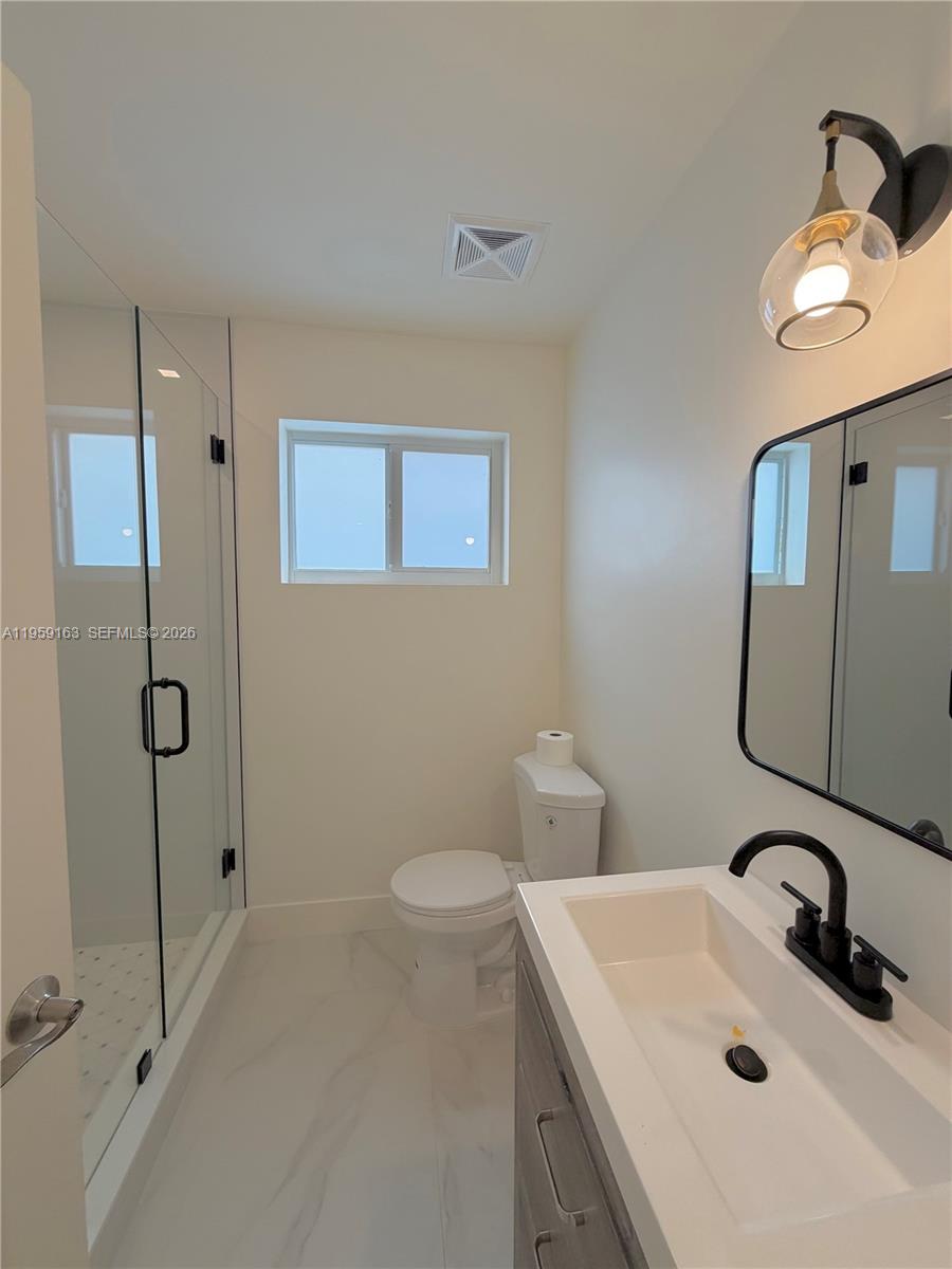 19221 Southwest 92nd Road Cutler Bay, FL 33157 - Photo 21 of 30 a bathroom with a sink a toilet and shower