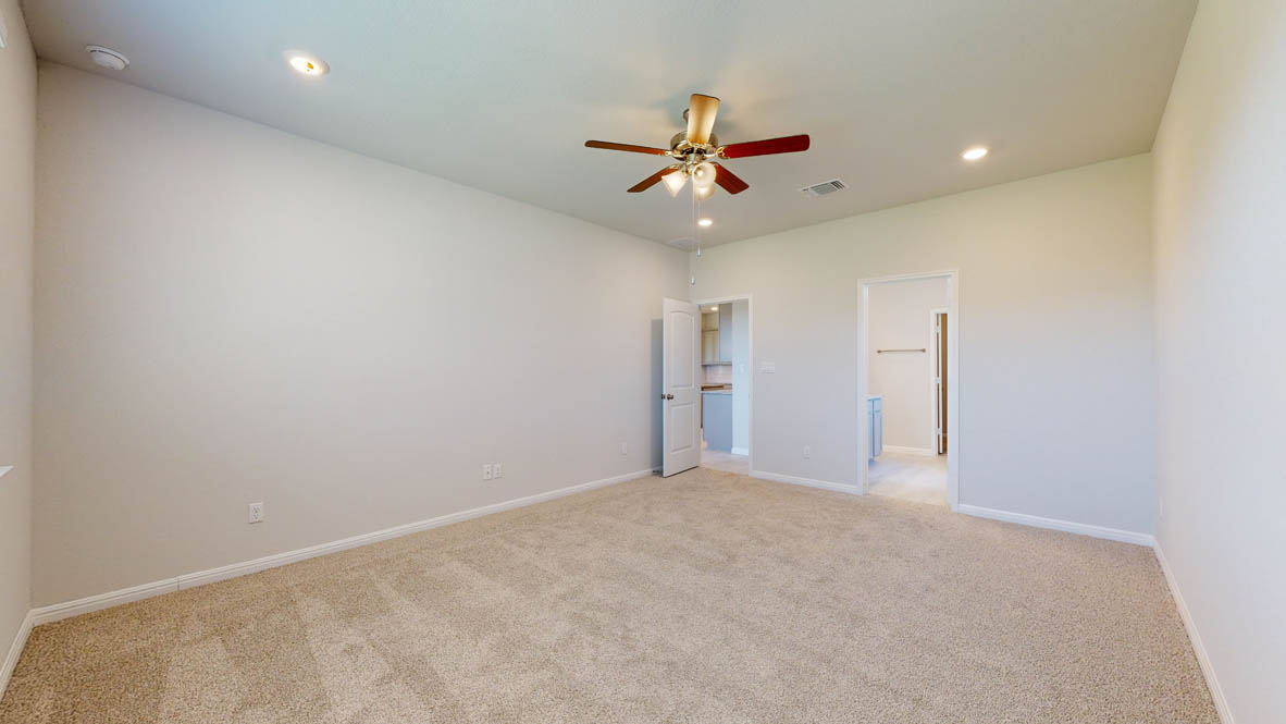 808 Gauge Road Thorndale, TX 76577 - Photo 11 of 31 A spacious, naturally illuminated room featuring plush carpeting and a modern ceiling fan.