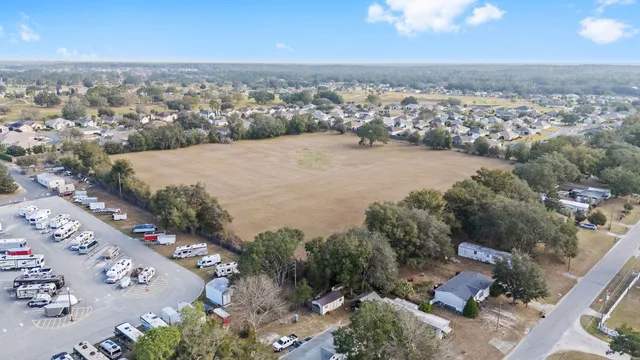 an aerial view of a house with a lake view