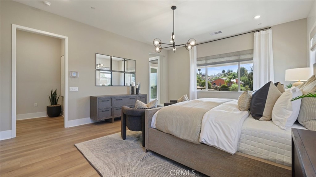 4971 Rideline Road Yorba Linda, CA 92887 - Photo 13 of 33 a bedroom with a bed chandelier and a window