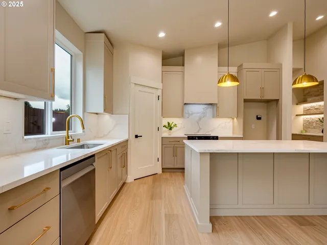 a kitchen with a sink a stove and a refrigerator