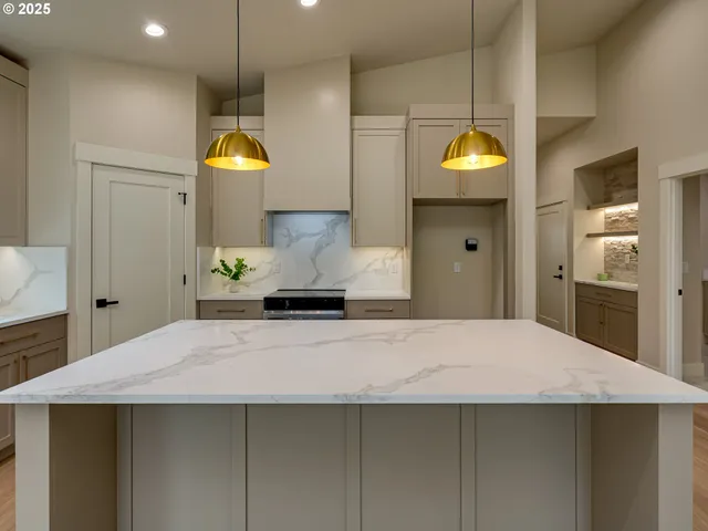 a kitchen with a refrigerator a sink and wooden floor