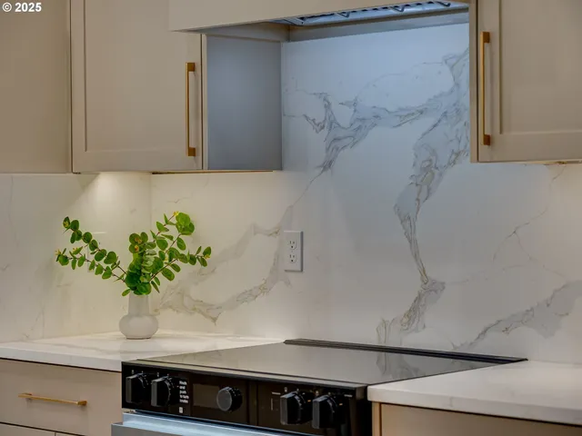 a white stove top oven sitting inside of a kitchen