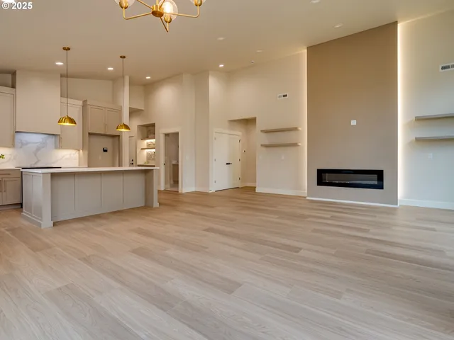 a view of a kitchen with a sink and a refrigerator