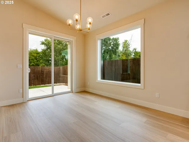 a living room with furniture kitchen view and a flat screen tv