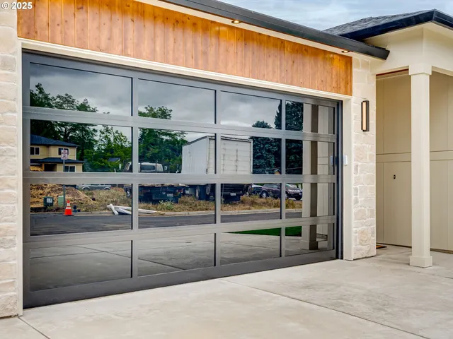a view of a hallway with wooden floor and cabinets