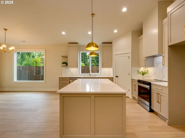 a view of a kitchen with a sink and wooden floor