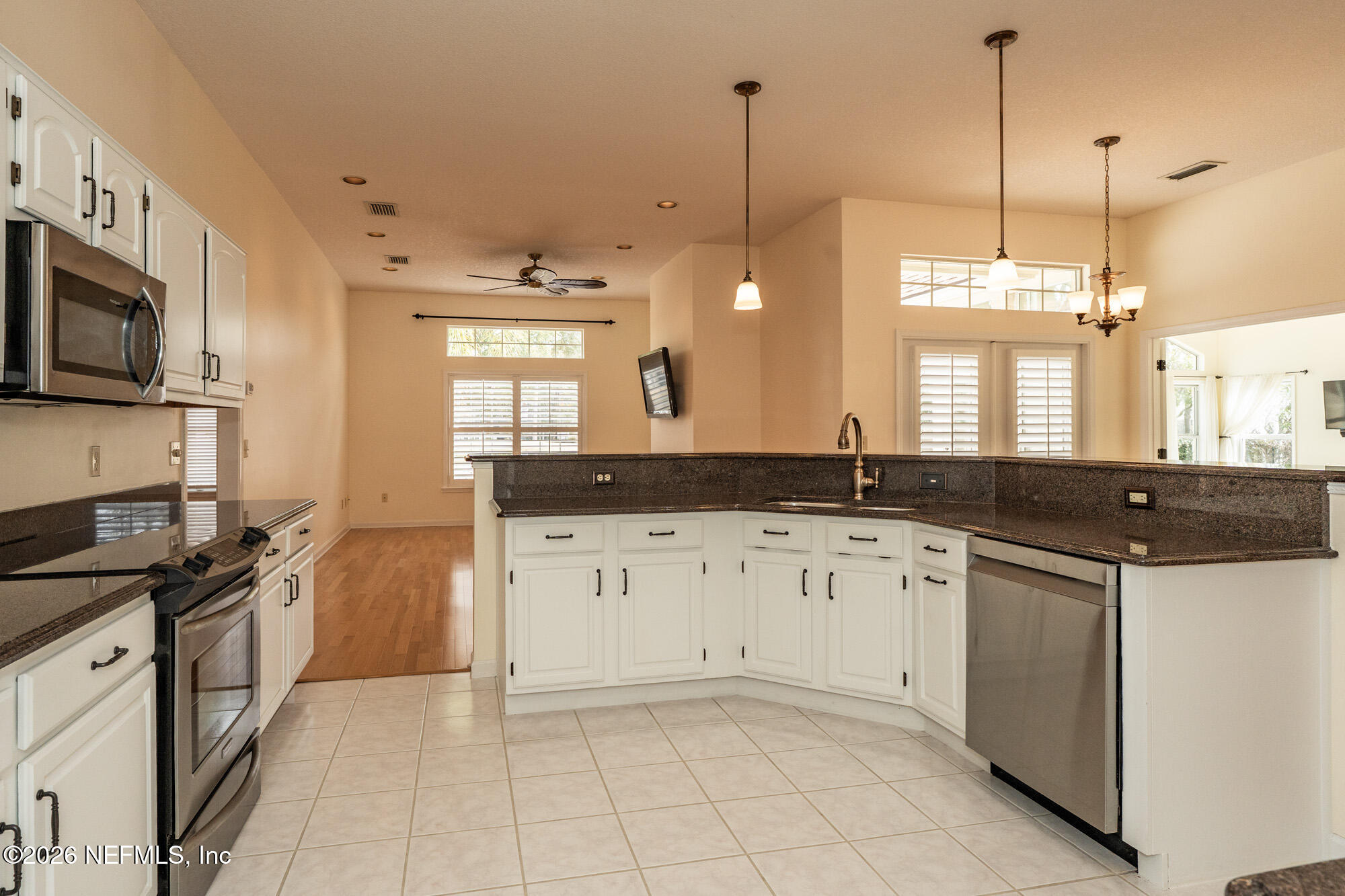 13177 Cricket Cove Road North Jacksonville, FL 32224 - Photo 13 of 39 a kitchen with granite countertop a sink a stove and cabinets