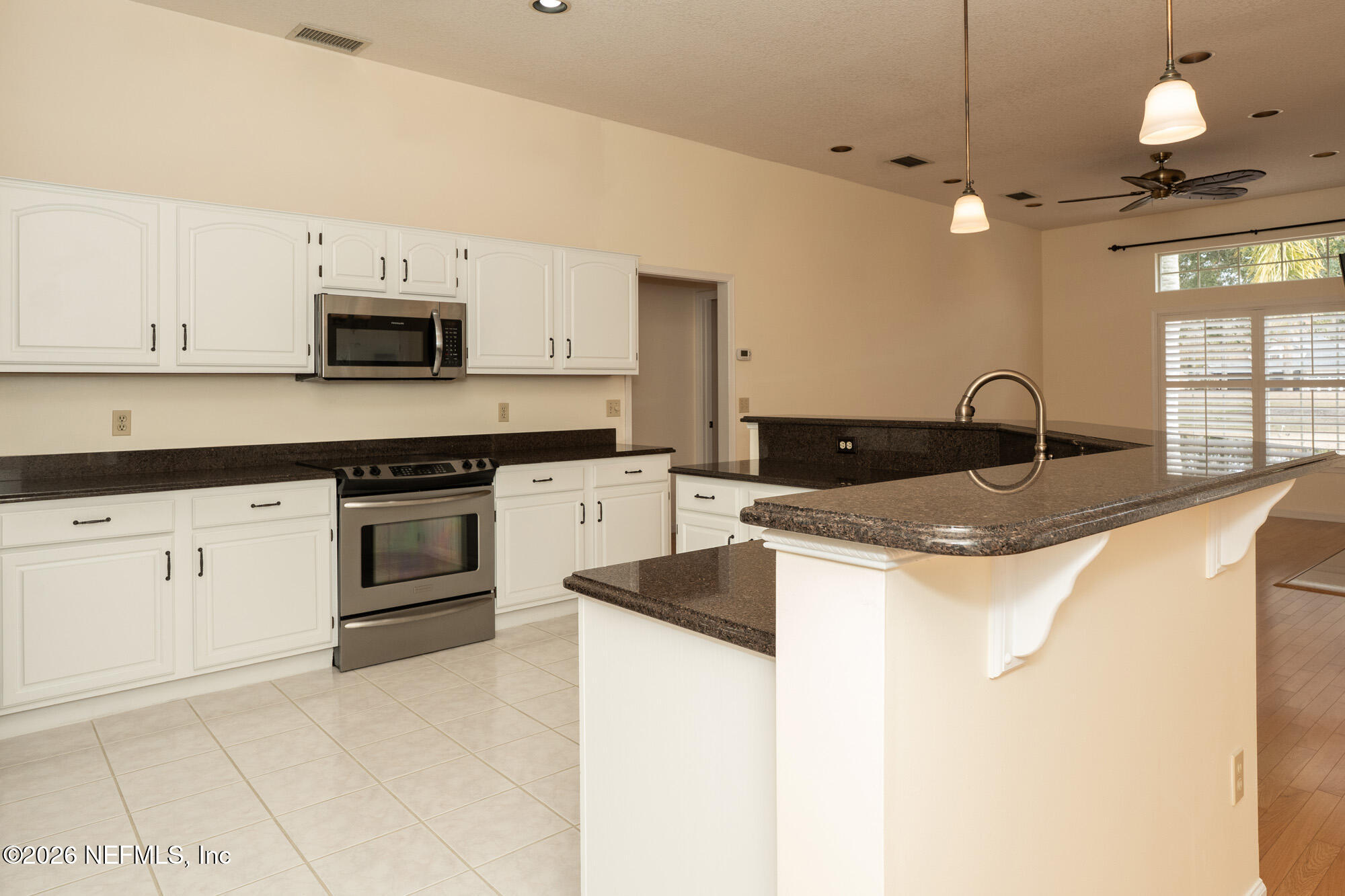 13177 Cricket Cove Road North Jacksonville, FL 32224 - Photo 14 of 39 a kitchen with granite countertop a sink and white cabinets