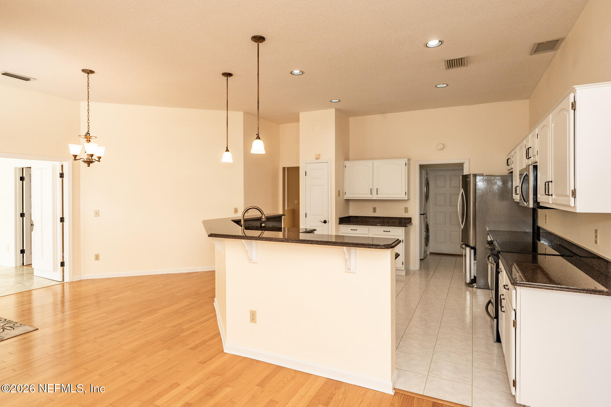13177 Cricket Cove Road North Jacksonville, FL 32224 - Photo 16 of 39 a view of a kitchen with kitchen island a counter top space a sink a refrigerator and window
