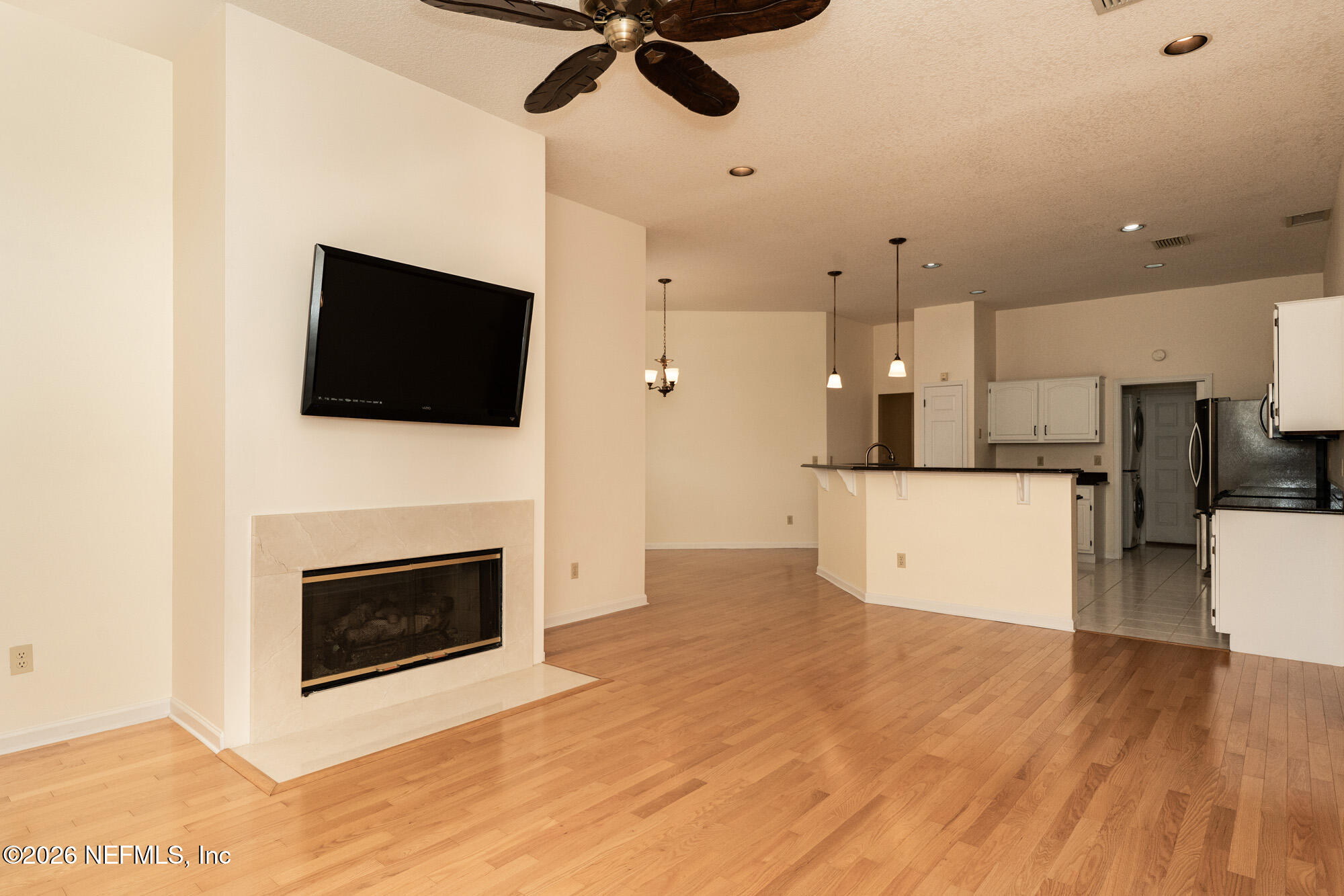 13177 Cricket Cove Road North Jacksonville, FL 32224 - Photo 18 of 39 a view of a kitchen and an empty room with a fireplace
