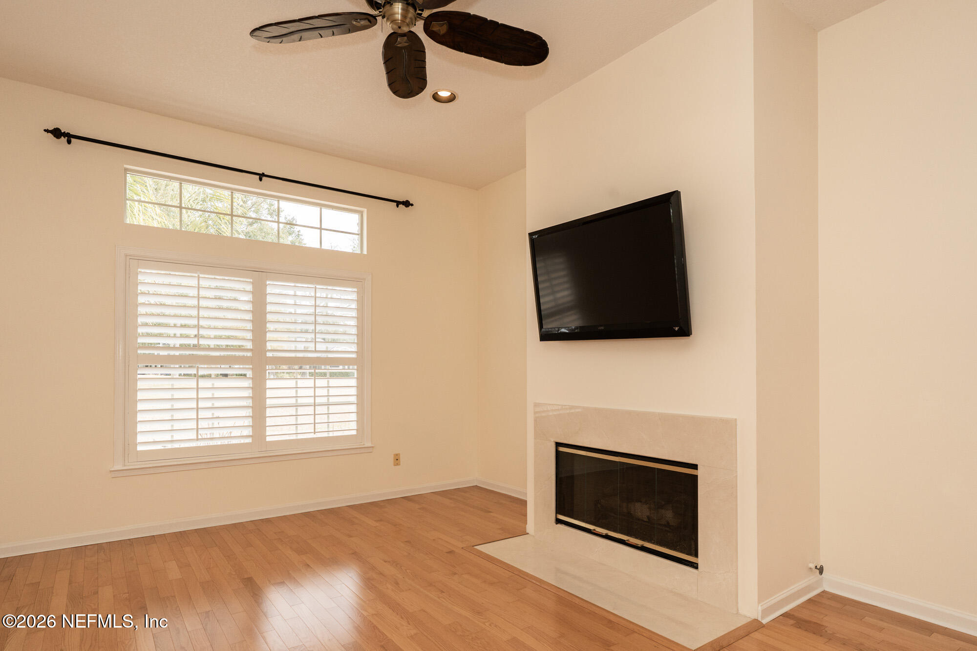 13177 Cricket Cove Road North Jacksonville, FL 32224 - Photo 19 of 39 a living room with a fireplace and a flat screen tv