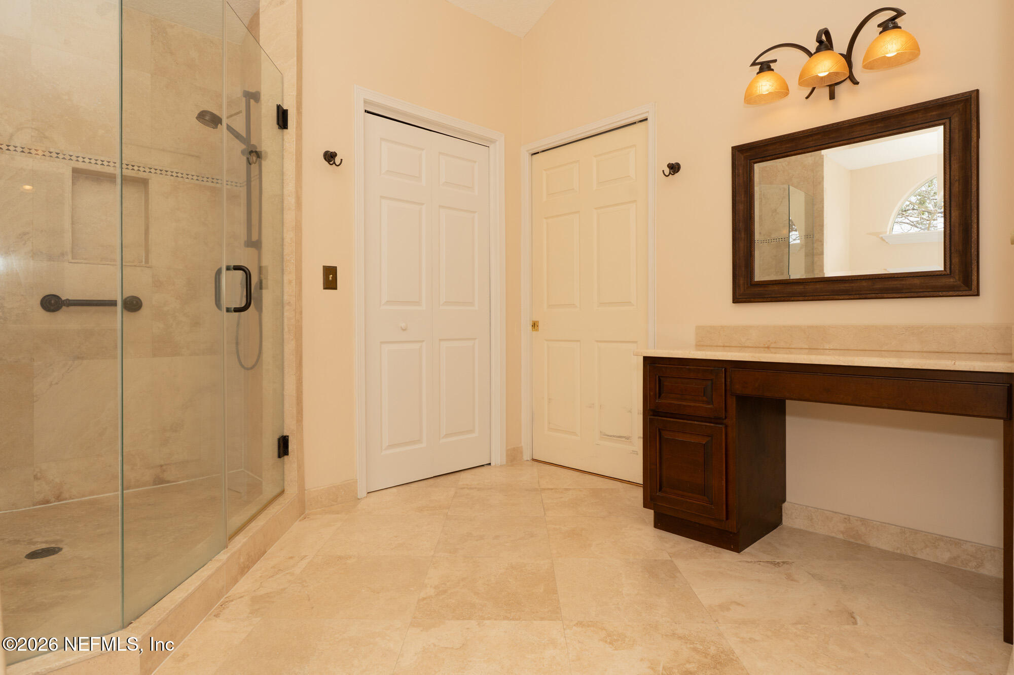 13177 Cricket Cove Road North Jacksonville, FL 32224 - Photo 27 of 39 a bathroom with a sink a mirror and shower