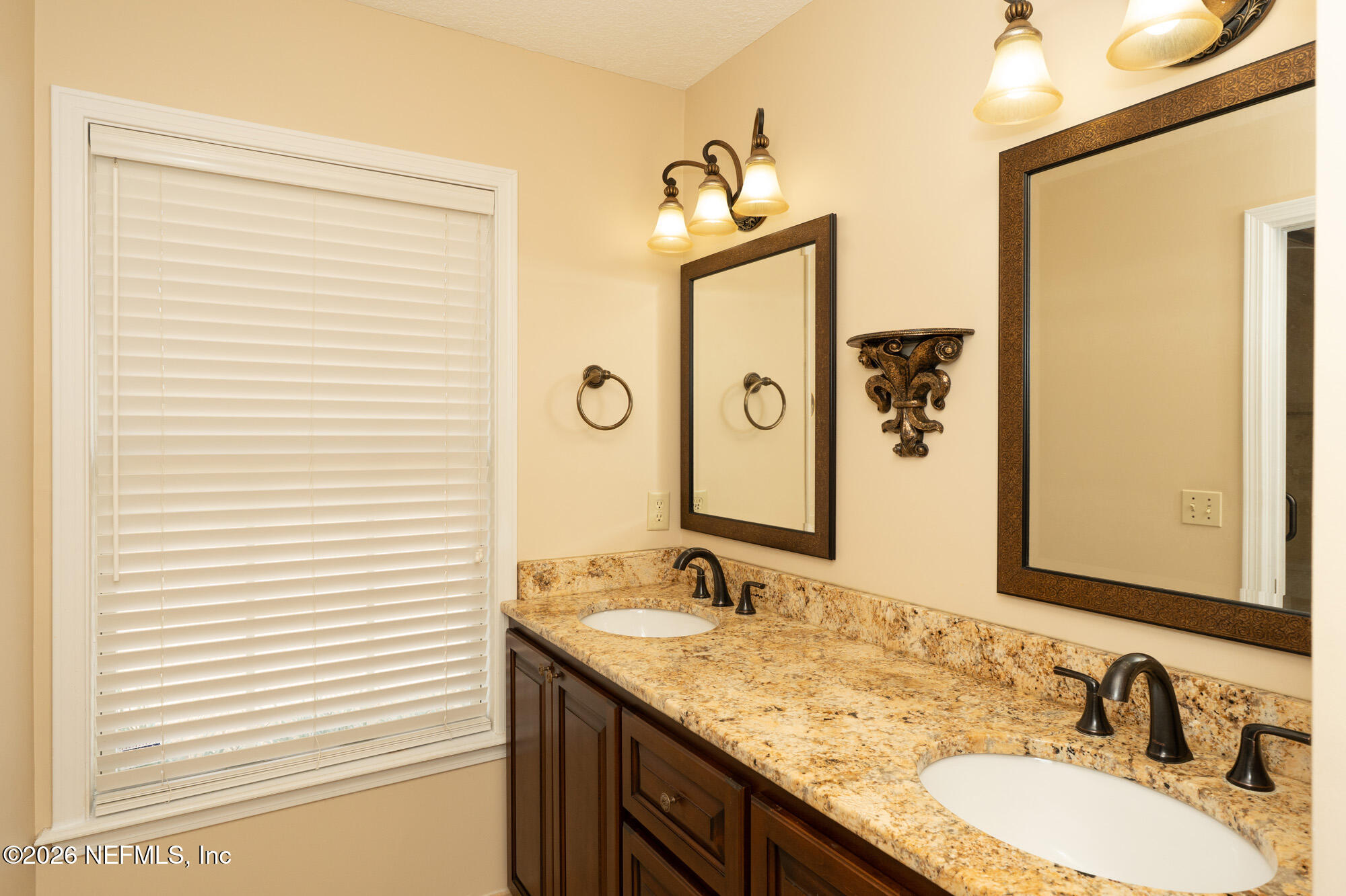 13177 Cricket Cove Road North Jacksonville, FL 32224 - Photo 29 of 39 a bathroom with a granite countertop sink and a mirror