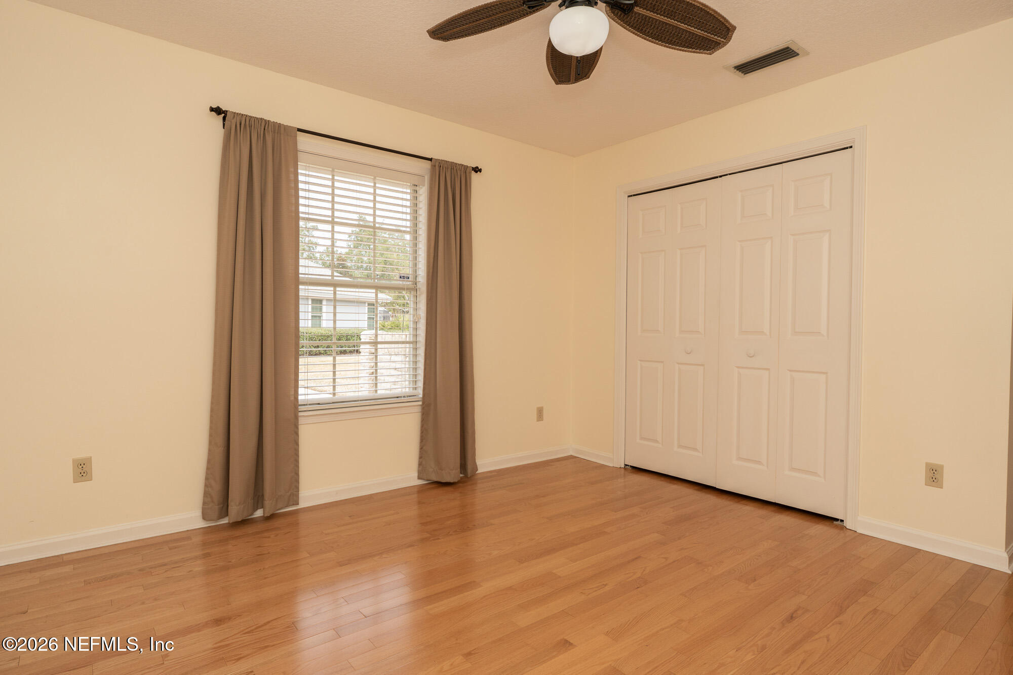 13177 Cricket Cove Road North Jacksonville, FL 32224 - Photo 32 of 39 an empty room with wooden floor and windows