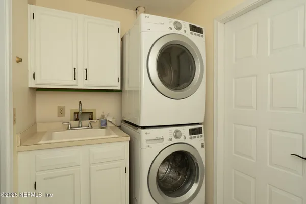 a utility room with sink dryer and washer