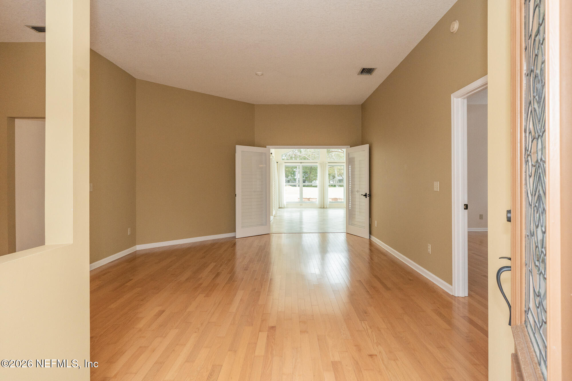 13177 Cricket Cove Road North Jacksonville, FL 32224 - Photo 7 of 39 a view of empty room with wooden floor and fan
