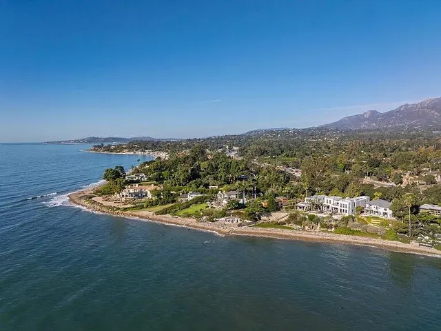 an aerial view of a house with a ocean view