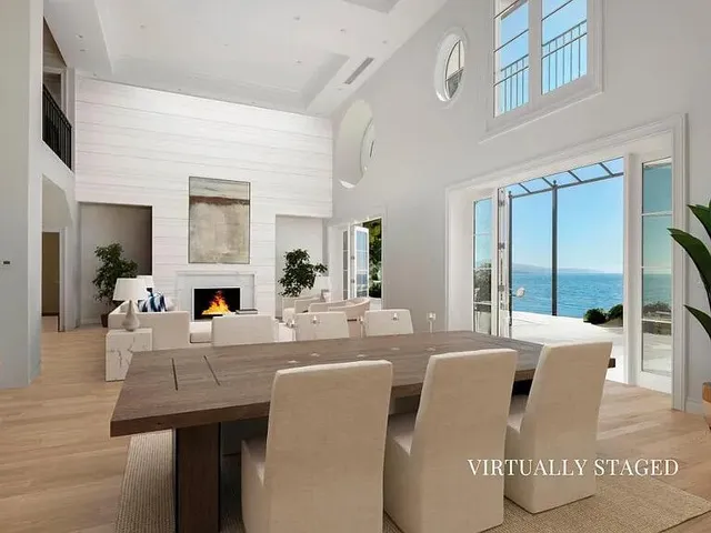 a view of a dining room with furniture and a large window
