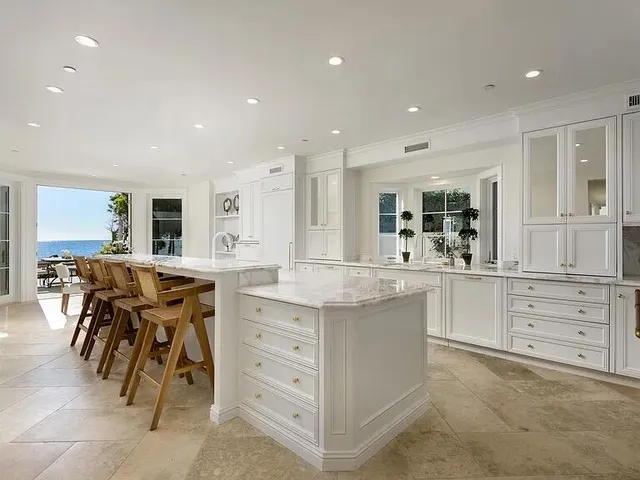 a kitchen with kitchen island cabinets and chairs