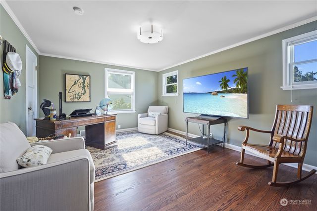 a living room with furniture a rug and a window