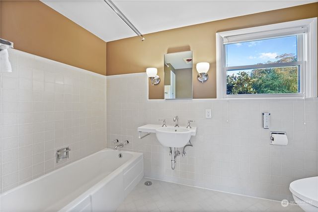 a bathroom with a sink a toilet and a bathtub