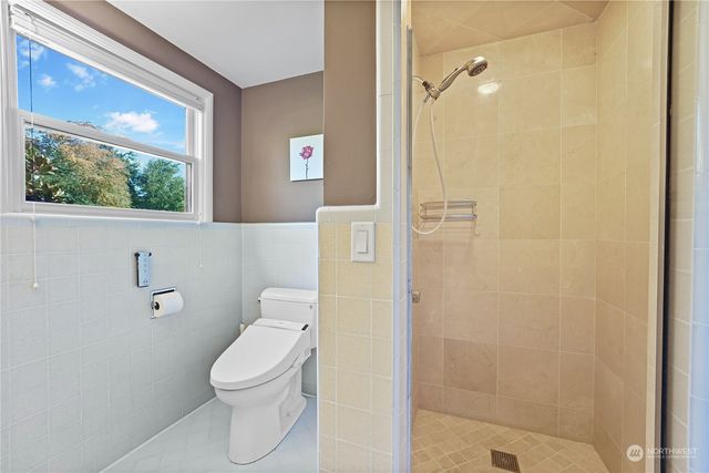a bathroom with a toilet and a shower