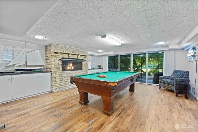 a view of a patio with a table and chairs under an umbrella with wooden fence