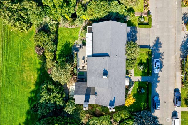 an aerial view of a house with a yard and garden