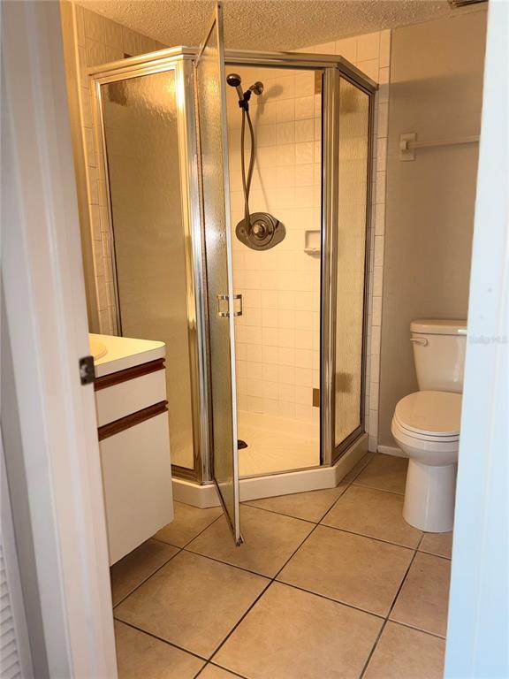 26485 Rampart Boulevard, Unit D1 Punta Gorda, FL 33983 - Photo 17 of 29 a bathroom with a granite countertop shower and a toilet