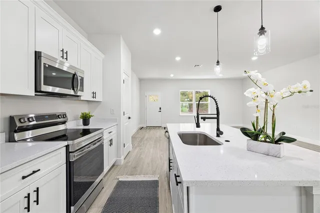 an empty room with wooden floor and mirror