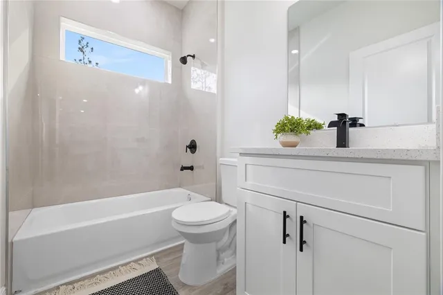 a front view of a house with a garden and yard