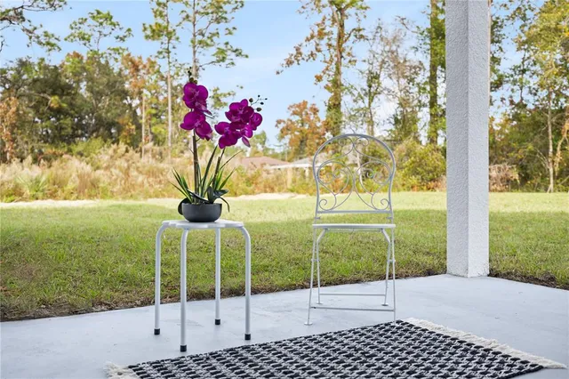 a aerial view of a house with swimming pool next to a yard