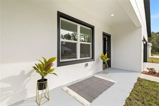 a living room with furniture and a view of kitchen