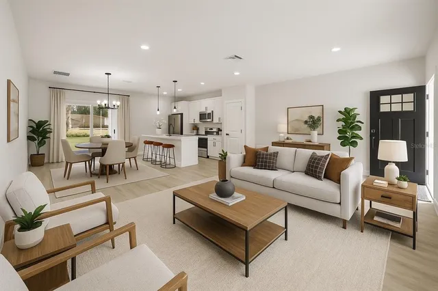 a kitchen with refrigerator and chairs