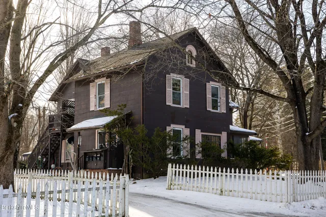 a front view of a house with a fence