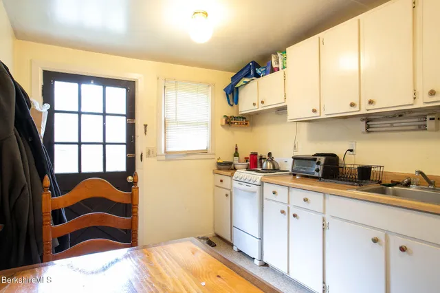 a kitchen with stainless steel appliances granite countertop a sink and cabinets