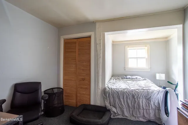 a bedroom with a bed and a chair