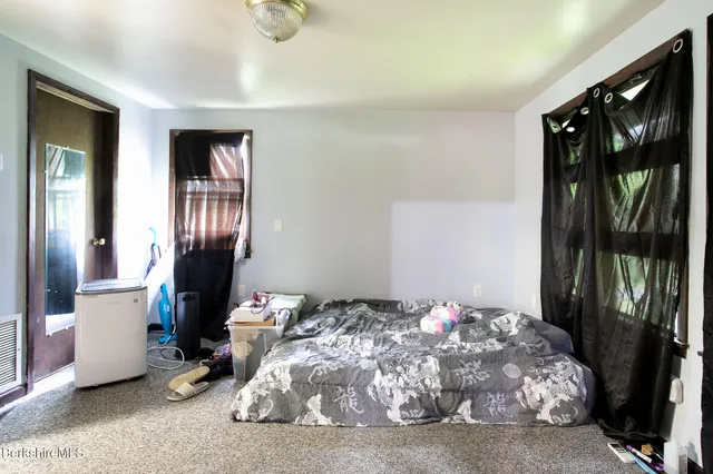 a bedroom with a bed and a mirror