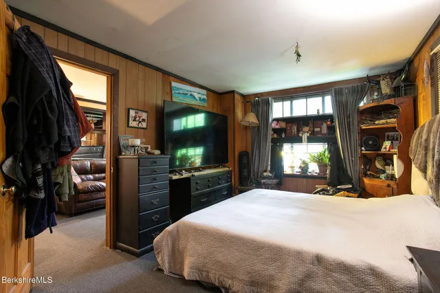 a bedroom with a large bed and a window