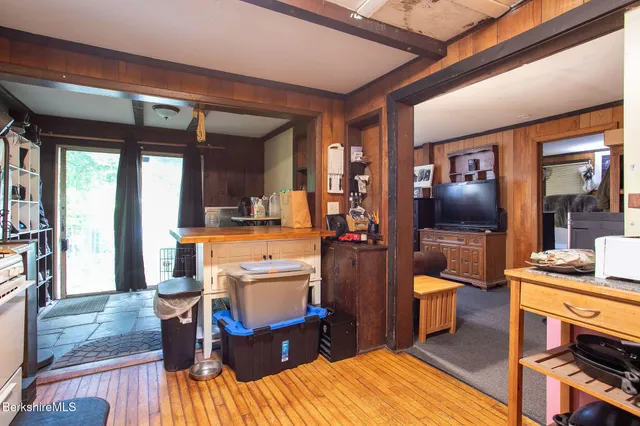 a living room with furniture a flat screen tv and a dining table