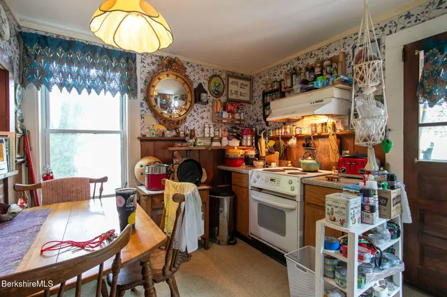 a dining room filled with furniture and a chandelier