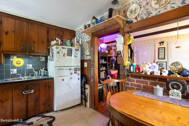 a kitchen with a refrigerator and a stove top oven