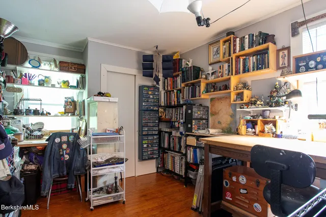 a room with furniture a bookshelf and a window